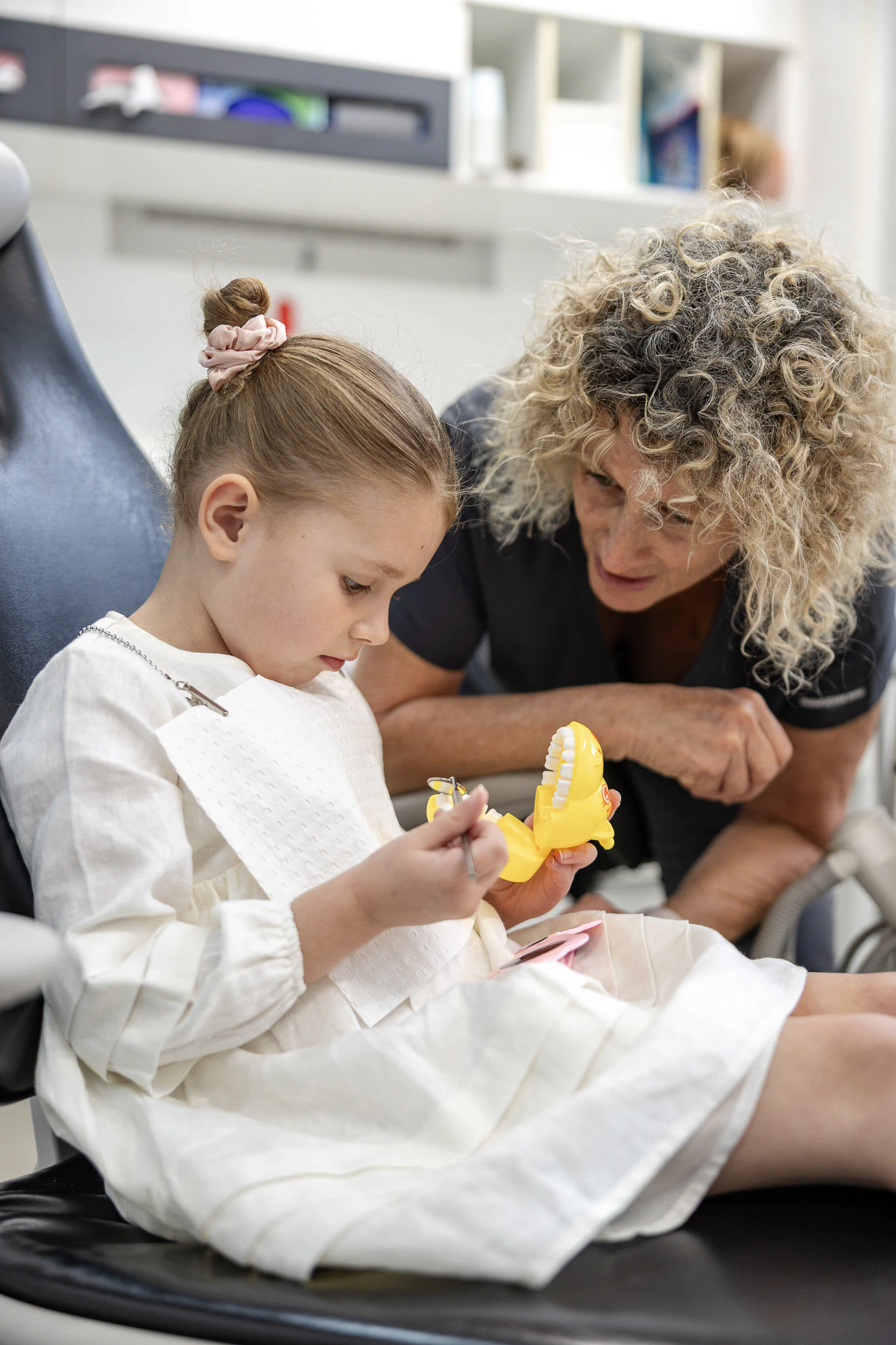 Young child with a dentist during a gentle check-up